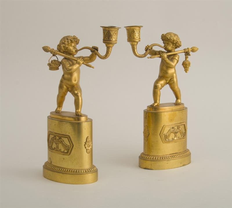 Appraisal: PAIR OF EMPIRE FIGURAL CANDLESTICKS Each modeled as a Bacchic