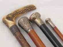 Appraisal: Four walking sticks one an antler handled hardwood with silver