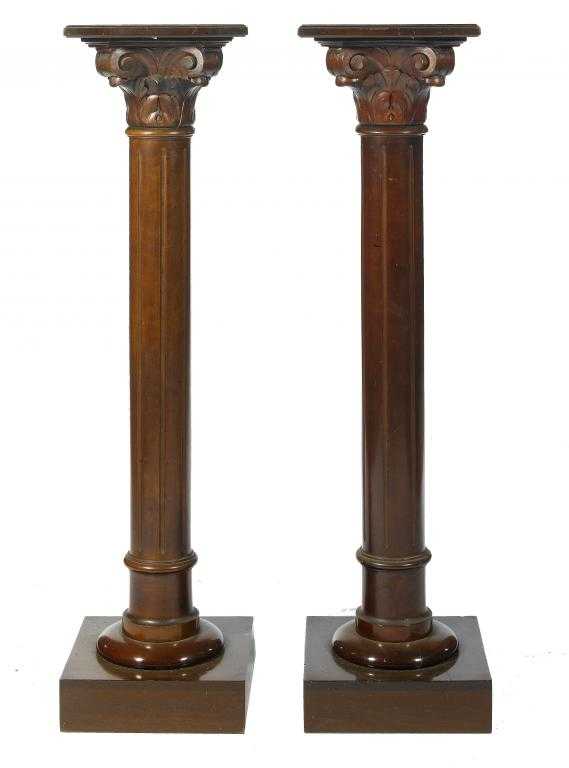 Appraisal: A PAIR OF MAHOGANY COLUMNAR TORCH RES the fluted hsaft