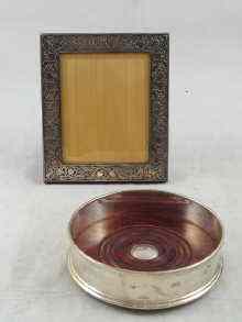 Appraisal: A silver photo frame with bevelled glass and Art Nouveau