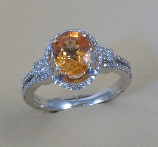 Appraisal: SPESSARTITE GARNET AND DIAMOND RING k white gold and centering