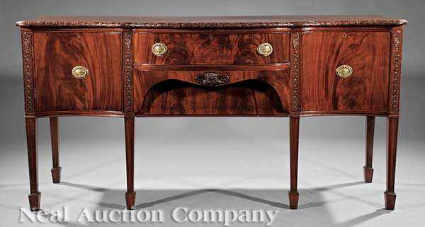 Appraisal: An Antique George III-Style Carved Mahogany Sideboard serpentine top with