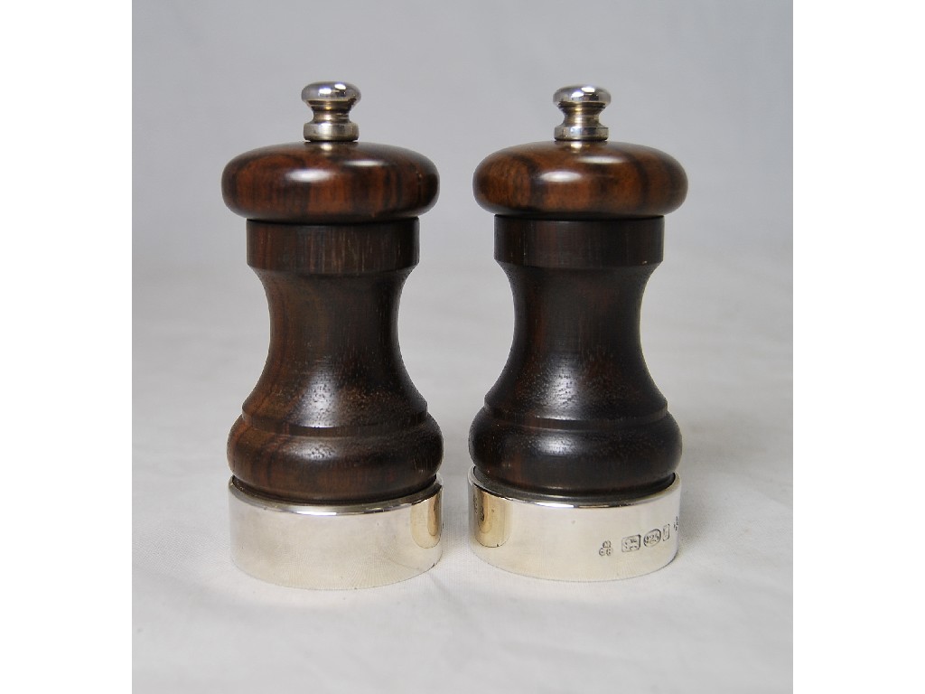 Appraisal: Pair of modern hardwood pepper mills having silver bases bearing