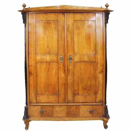 Appraisal: A Bavarian Biedermeier Ebonized Cherry Armoire circa having turned finials