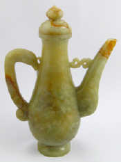 Appraisal: A Chinese celadon jade ewer and cover th c approx