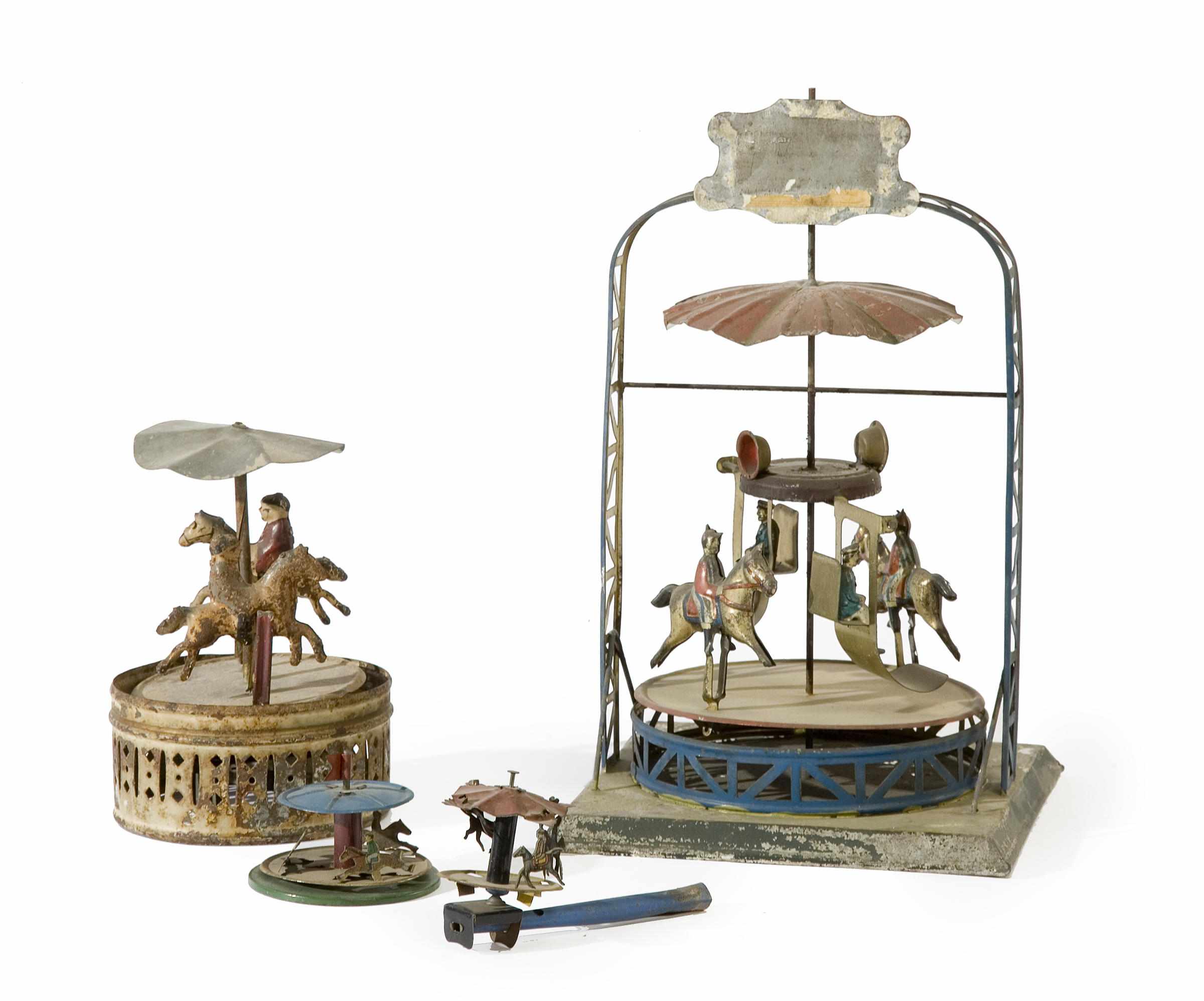 Appraisal: A group of four German painted tin carousel toys late