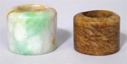 Appraisal: Two Chinese jade archer's rings The largest and widest hollowed