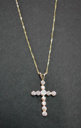 Appraisal: Fourteen-Karat Yellow Gold and Diamond Cross Pendant Necklace the cross