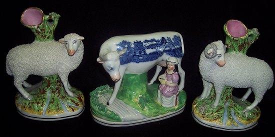 Appraisal: A pair of Staffordshire vases each with sheep leaning against