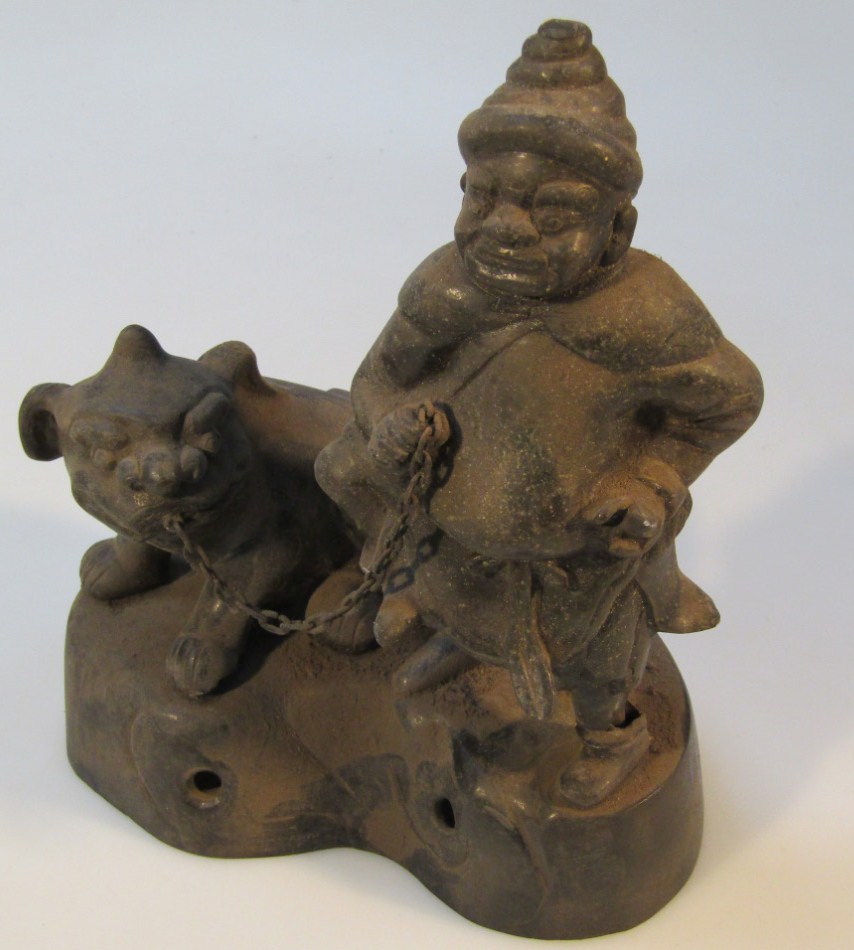 Appraisal: An unusual oriental cast metal figure group formed as a