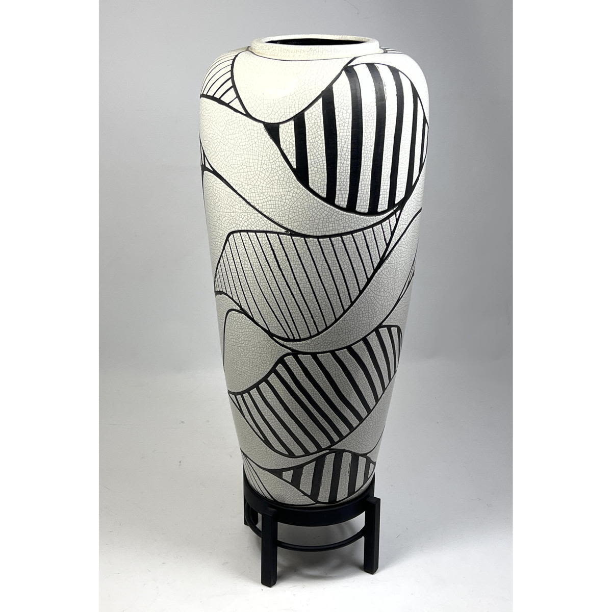 Appraisal: Black and white pottery and metal floor vase Eggshell Crackle