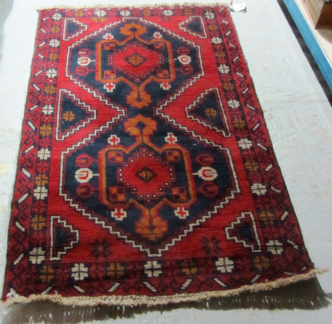 Appraisal: A Beluche rug the madder field with two bold medallions