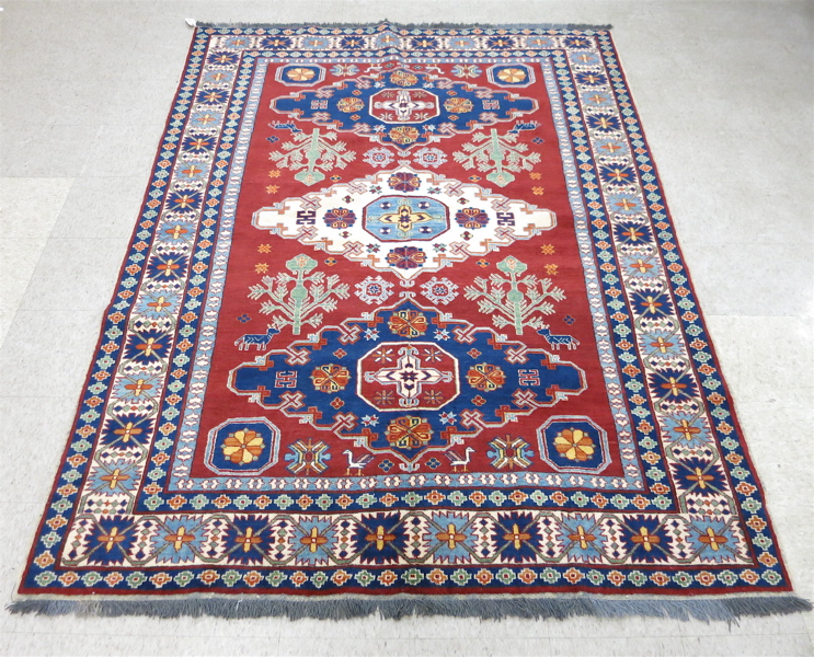 Appraisal: HAND KNOTTED ORIENTAL CARPET Pakistani Kazak triple medallion and stylized