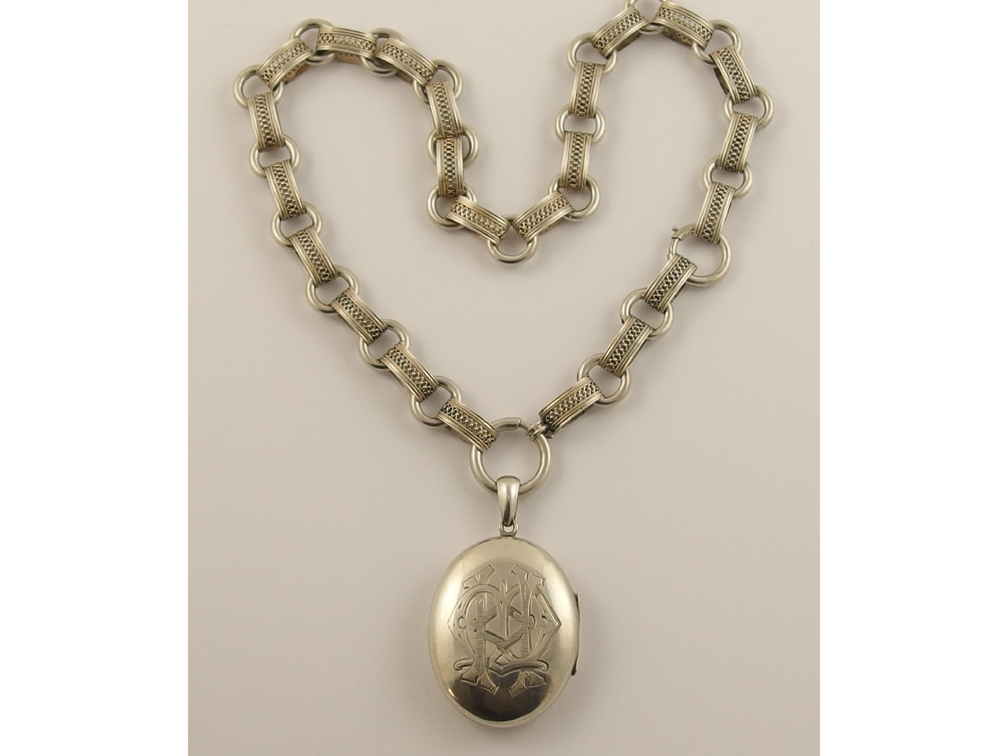 Appraisal: A Victorian white metal locket and decorative chainthe oval locket