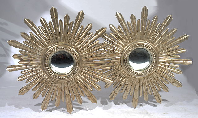 Appraisal: A PAIR OF SILVER PAINTED SUNBURST WALL MIRRORS with central