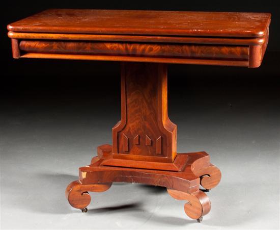 Appraisal: American Restoration carved mahogany flip-top games table circa with pedestal