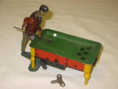 Appraisal: A novelty bar billiards player tin plate clockwork motor operates