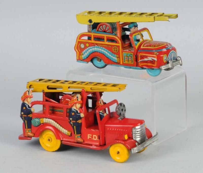 Appraisal: Lot of Tin Fire Engine Friction Toys Description Japanese Working