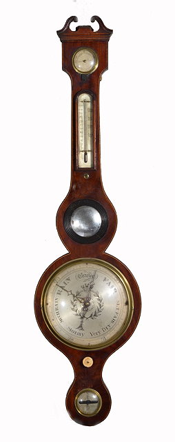 Appraisal: A GEORGIAN MAHOGANY WHEEL BAROMETER with silvered dials with thermometer