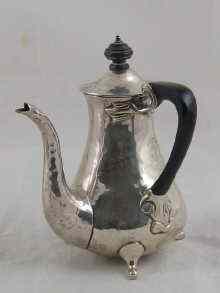 Appraisal: An Art Nouveau silver side handled chocolate pot with hammered