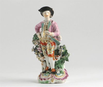 Appraisal: A Chelsea figure of a young lover standing before flowering