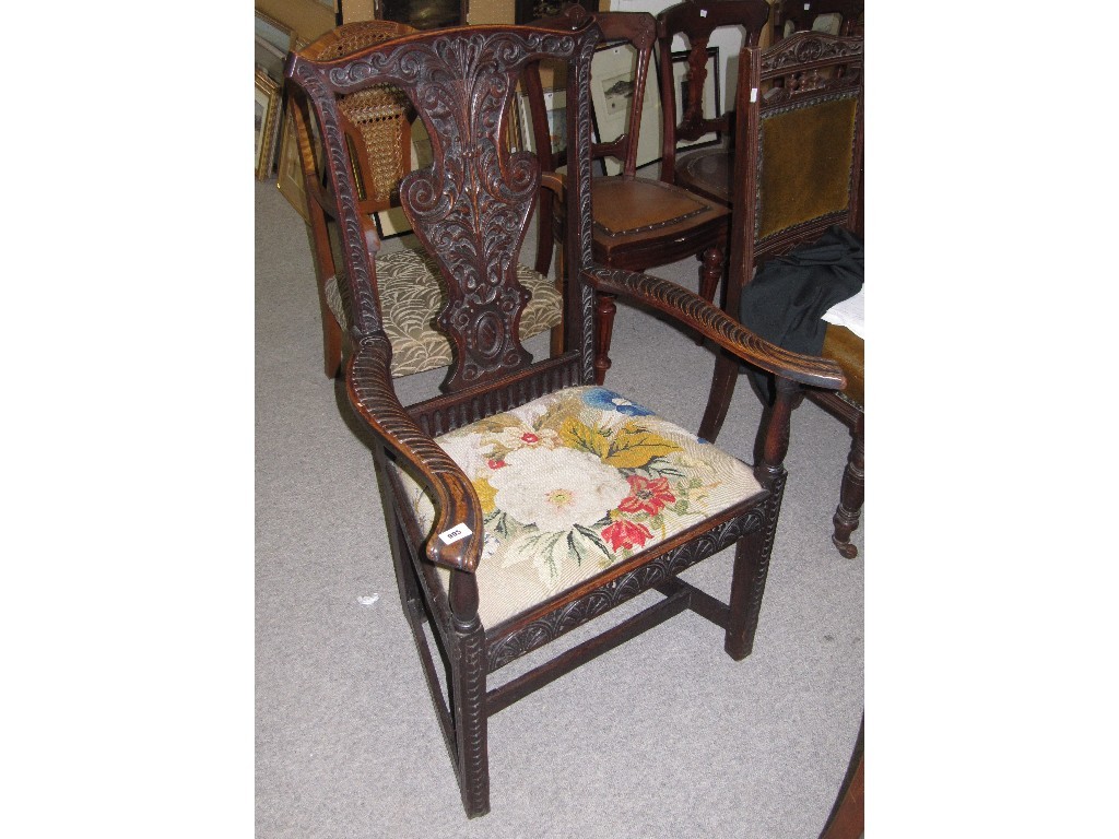 Appraisal: Victorian carved oak elbow chair with floral embroidered seat