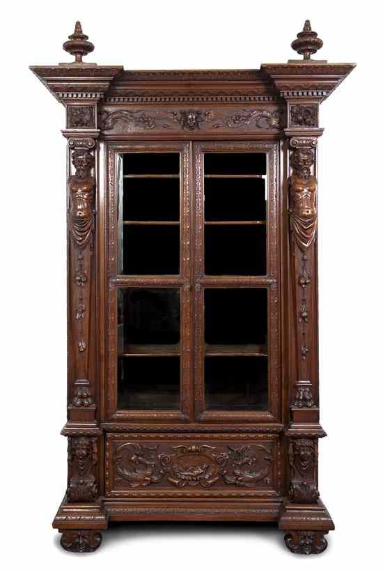 Appraisal: A Baroque Style Mahogany Vitrine having two finials over the