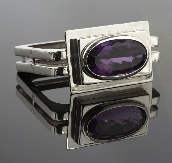 Appraisal: An amethyst bangle centering a large faceted amethyst in a