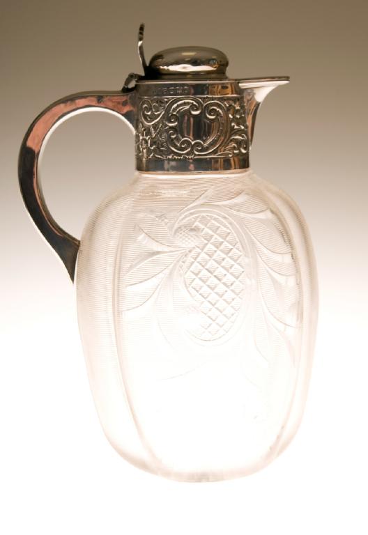 Appraisal: VICTORIAN SILVER-MOUNTED CUT-GLASS CLARET JUG SHEFFIELD the ovoid ribbed glass