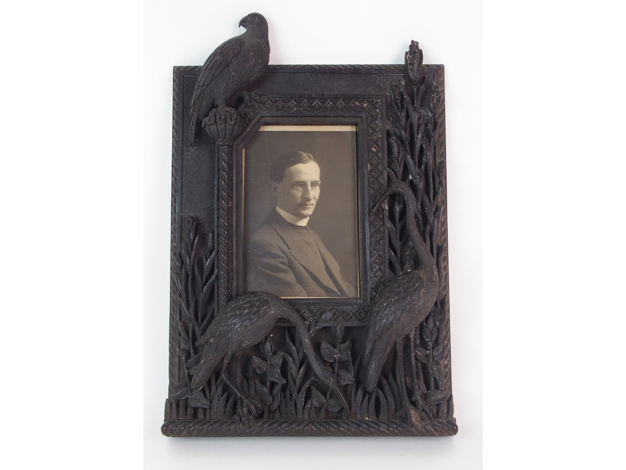 Appraisal: A hardwood carved table photograph framecarved in high relief with