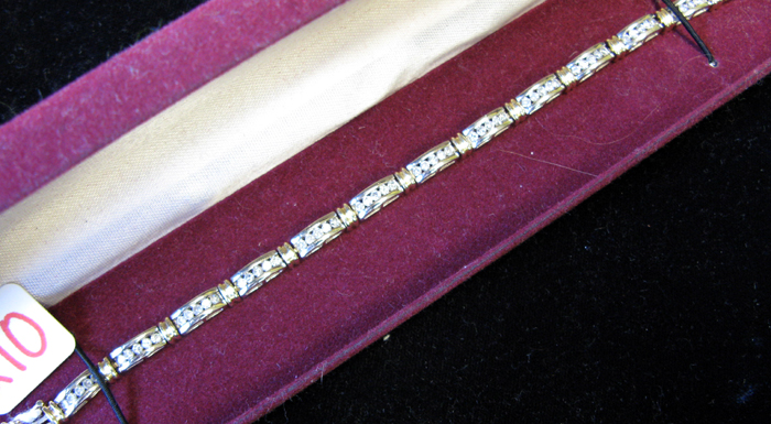 Appraisal: DIAMOND AND FOURTEEN KARAT WHITE AND YELLOW GOLD BRACELET inch