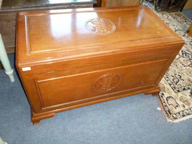 Appraisal: A CAMPHORWOOD LINEN BOX carved with oriental symbols and standing