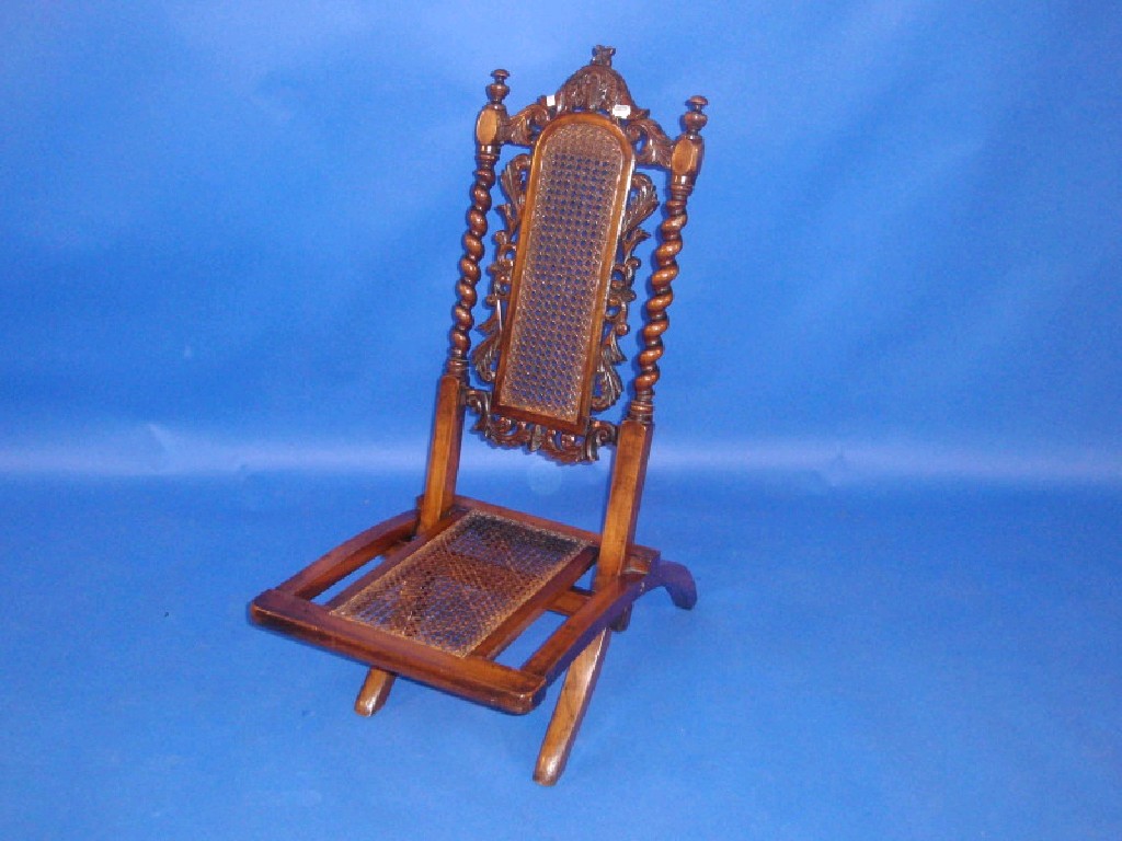 Appraisal: A Victorian beech folding chair in the Jacobean style with