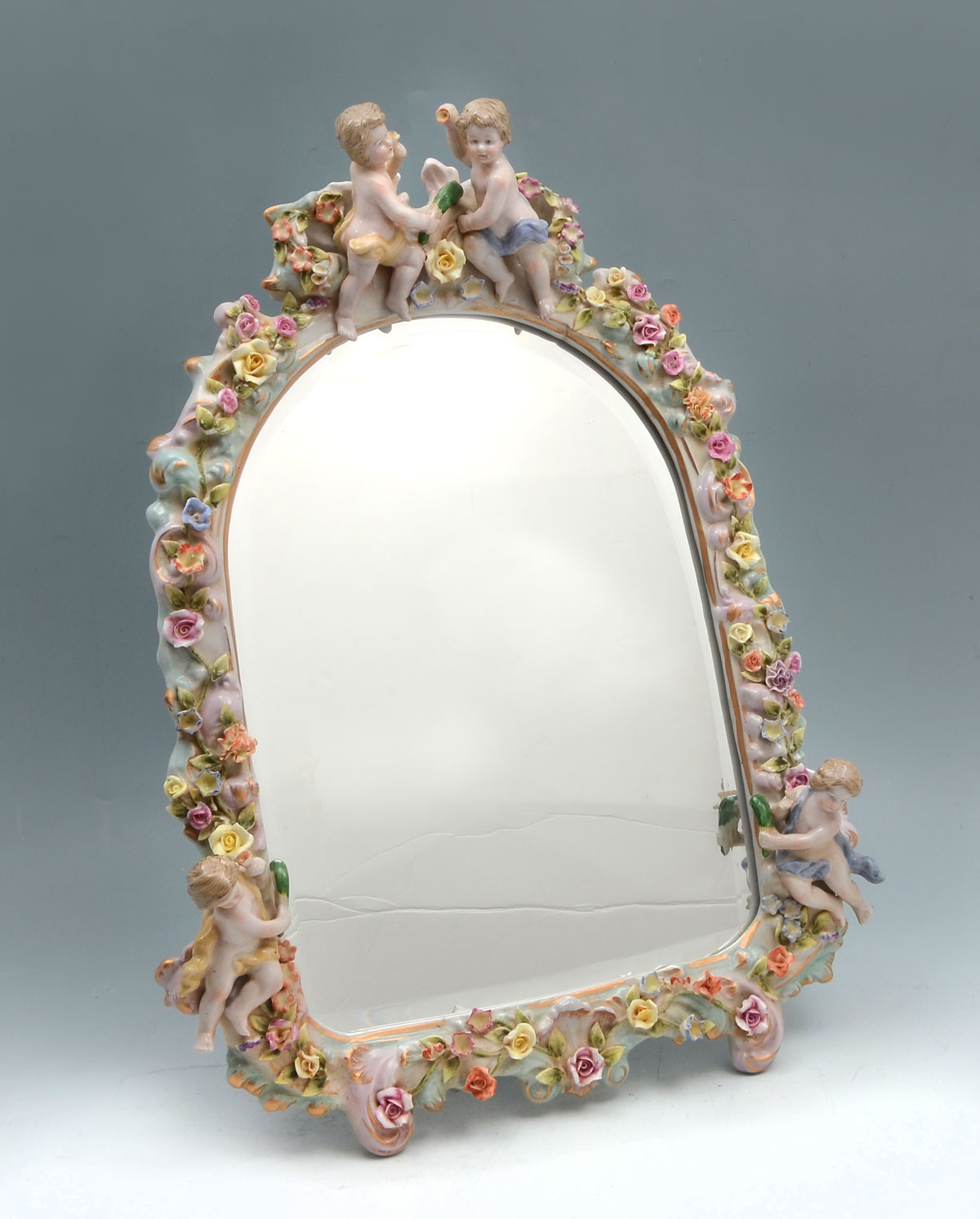 Appraisal: MEISSEN CHERUB MIRROR Meissen porcelain frame having attached cherubs amongst