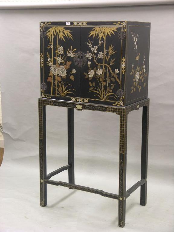 Appraisal: A japanned wood cupboard on stand pair of doors painted