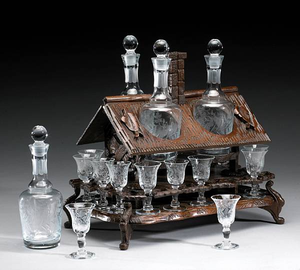 Appraisal: A Black Forest lindenwood liquor set late th early th