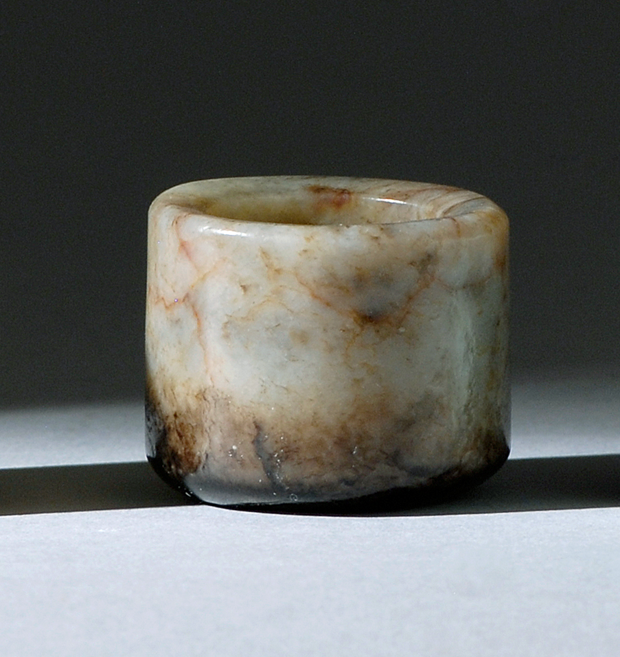 Appraisal: BLACK AND MUTTON-FAT JADE ARCHER'S RING th CenturyIn cylinder form