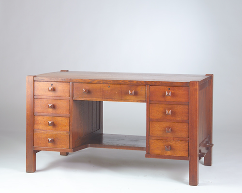 Appraisal: GUSTAV STICKLEY Early desk with nine drawers chamfered sides the