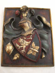 Appraisal: A hardwood armorial coat of arms deeply carved in high