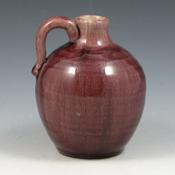 Appraisal: Pisgah Forest handled jug in plum gloss from the s