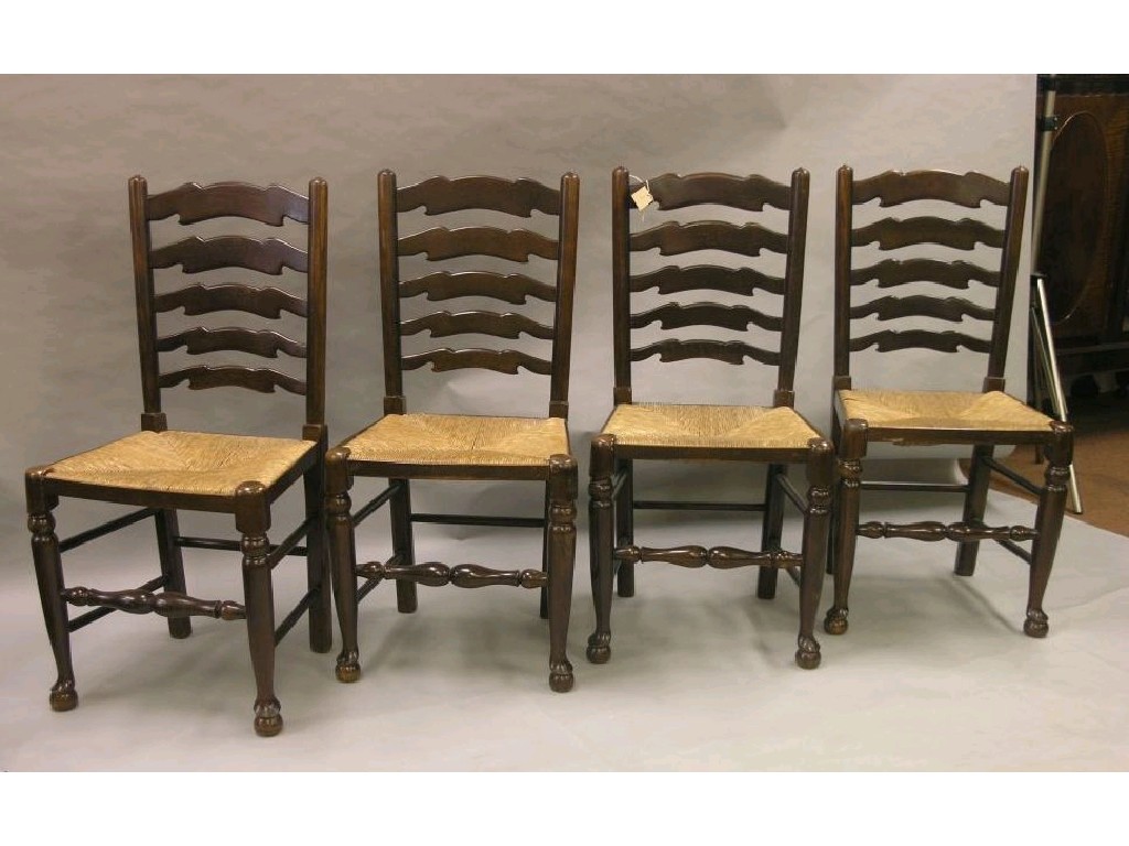 Appraisal: A set of four reproduction dark oak ladder-back dining chairs