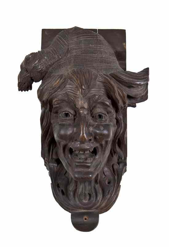 Appraisal: An Austrian Carved Wood Mask Fragment depicting a Bacchic grotesque