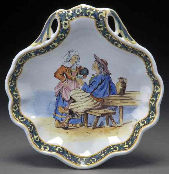 Appraisal: Porquier-Beau Quimper shell form dishdepicting a painted tavern scene with