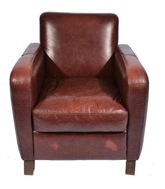 Appraisal: A BROWN LEATHER UPHOLSTERED ARMCHAIR standing on short square section