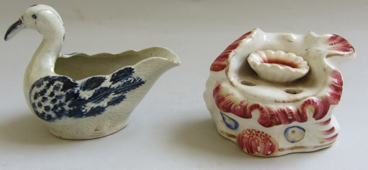 Appraisal: A pearlware blue and white creamboat in the form of