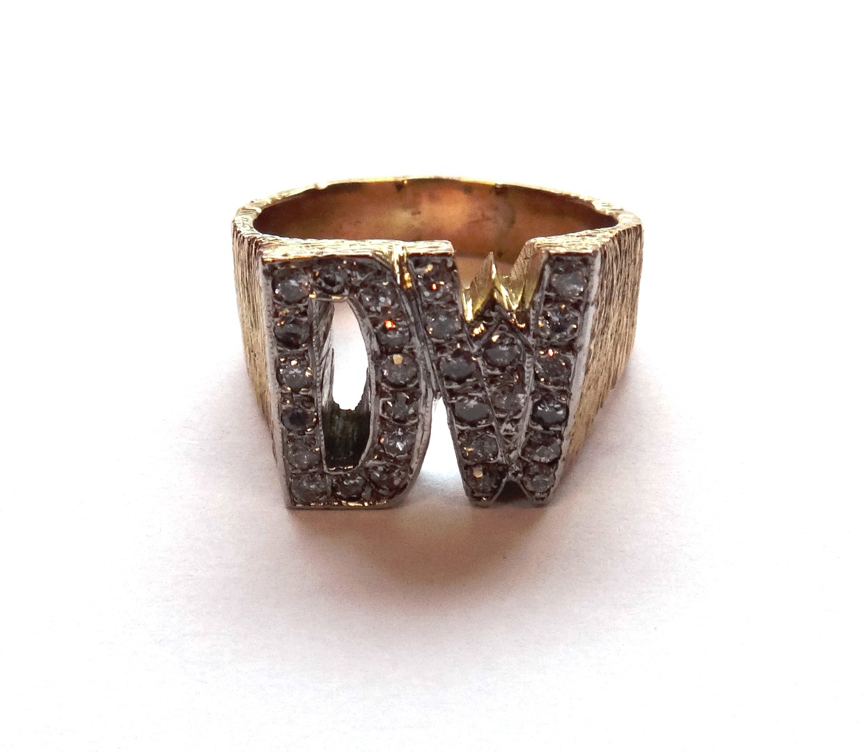 Appraisal: A gold and diamond set ring designed as the initials