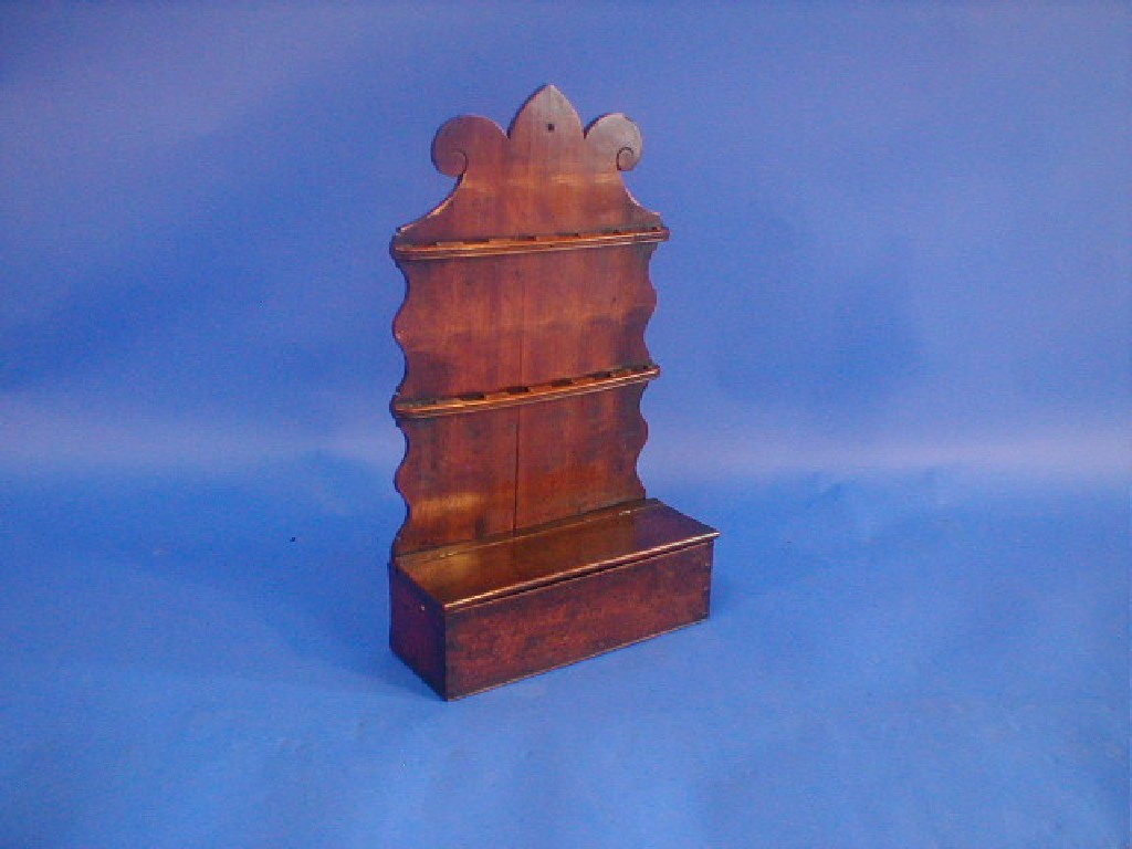 Appraisal: A George III mahogany spoon rack with trefoil and scroll