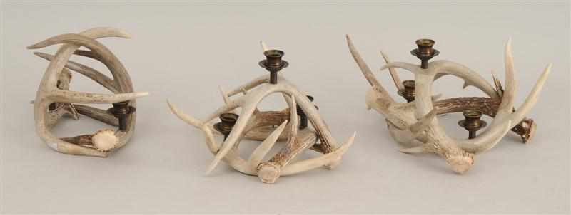 Appraisal: THREE BRASS-MOUNTED ANTLER CANDELABRA Two with three nozzles the last