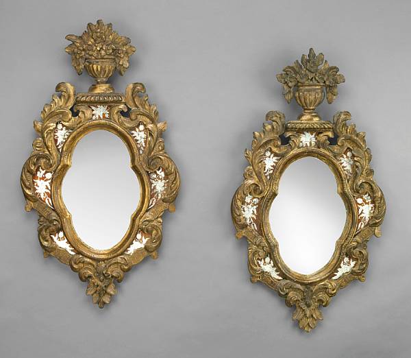 Appraisal: A pair of Italian Rococo style giltwood and eglomise mirrors