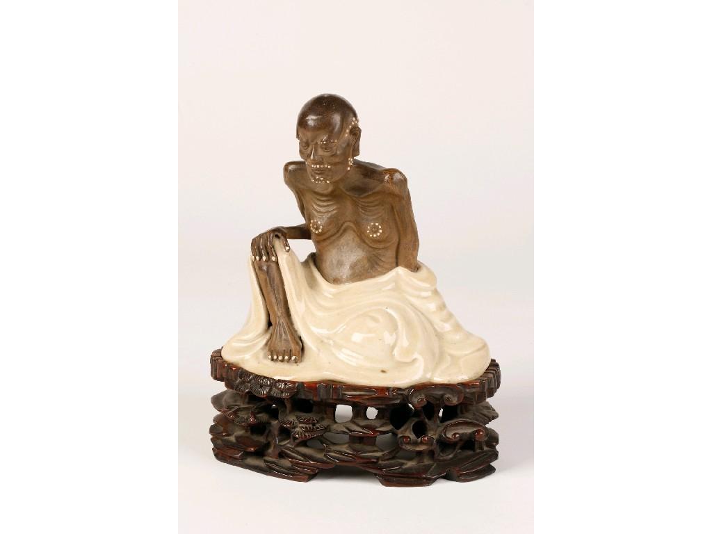 Appraisal: A JAPANESE GLAZED EARTHENWARE FIGURE OF AN OLD MAN on